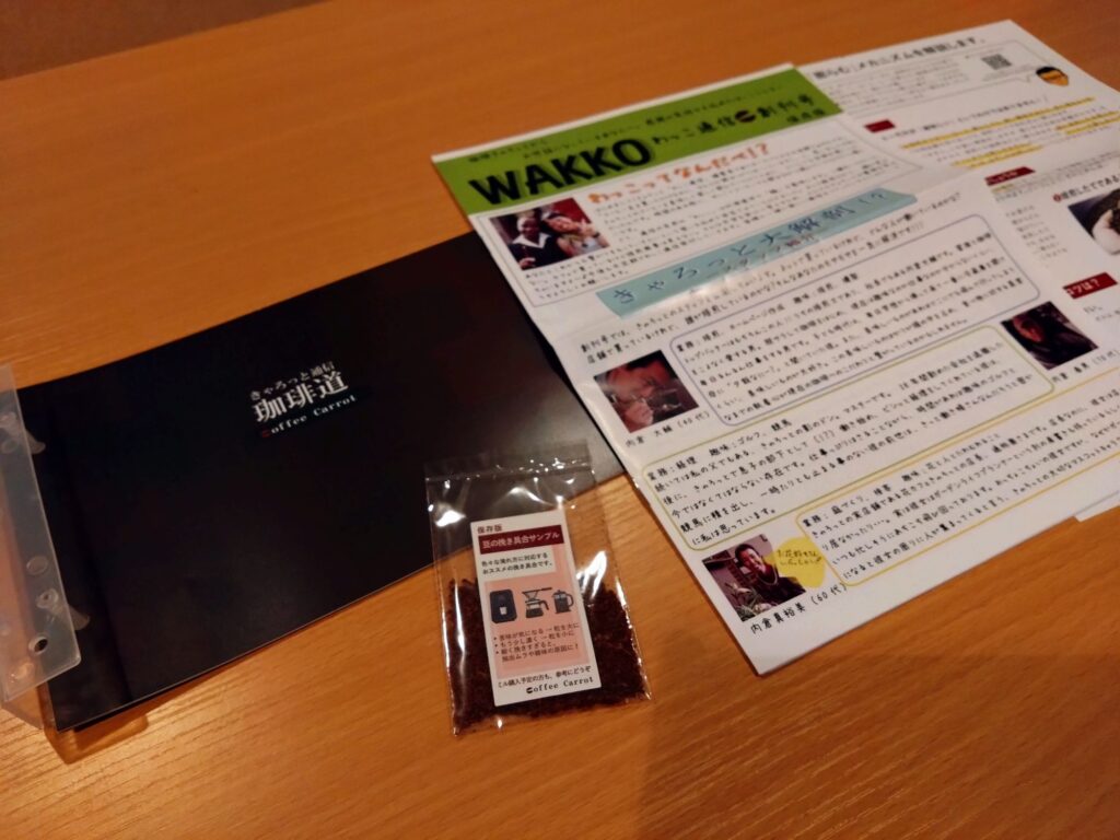 珈琲きゃろっと「初回限定お試しセット」に同梱されている、焙煎士のこだわりが書かれた手紙や案内パンフレット。「珈琲道」と書かれた冊子などがテーブルに広げられている様子。